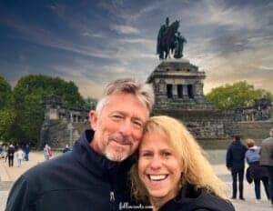 This image features Lisa, of followsoots.com, with her husband, in front of a statue in Koblenz, Germany