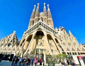This image features a full frontal view of the Sagrada Familia in Barcelona, Spain