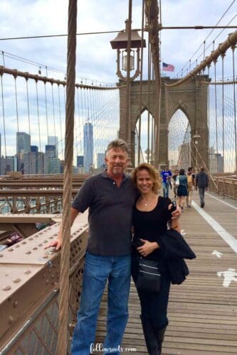2 Day NYC Itinerary - Image is of Lisa, of Followsoots.com, and her husband standing on the Brooklyn Bridge.