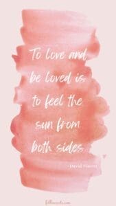 This image has a pale pink background with a darker pink paint swirl, and a quote that says, “To love and be loved is to feel the sun from both sides.”David Viscott
