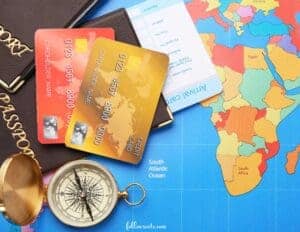 This image features a map of Afric, a compass, two credit cards, and passports. 