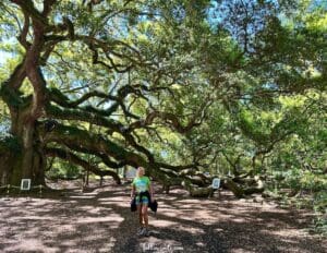 This image features Angel Oak Tree on Johns Island near Charleston. Lisa, the owner of followsoots.com is standing in front of the massive tree to give perspective to the incredible size of the tree.