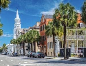 Pretty Places in Charleston - This image features a view of St Andrews Church and colorful buildings along Broad Street in Charleston