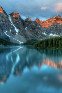 This image features a gorgeous view of Lake Louise with towering mountains in the background and blue lake in the foreground. Photo by James Wheeler Unsplash - Beautiful Travel Aesthetic Wallpapers