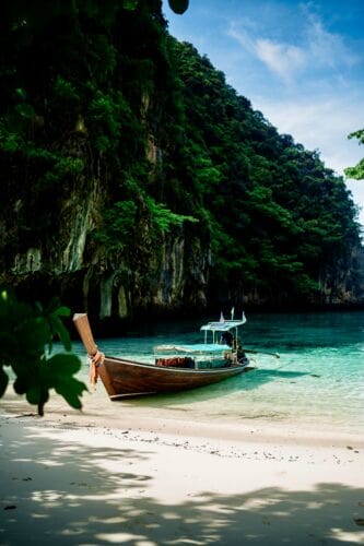 This image features an iconic boat in Thailand on the beach in a tropical cove. - Beautiful Travel Aesthetic Wallpapers