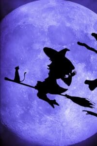 This Halloween Aesthetic wallpaper features a silhouette of a witch flying on a broom with a cat and the a large purple moon glowing behind her. 