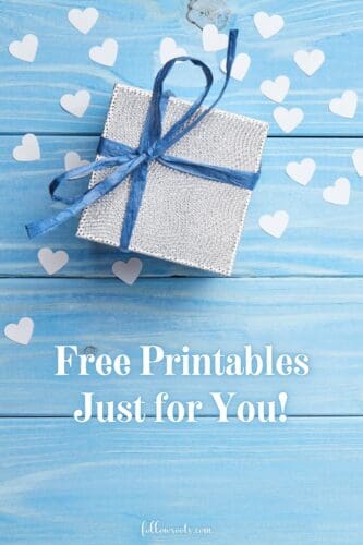 Free Printables from followsoots.com. This image shows a small white box with a blue ribbon tied in a bow. There are also small white hearts scattered around the box.
