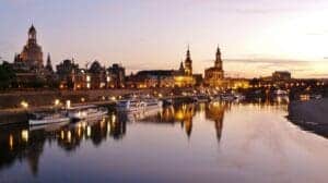 This image features a European city skyline at sunset