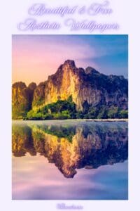 This image is a Pinterest Pin that features a mountain refelcting in a lake with the title, Beautiful & Free Aesthetic Wallpapers.