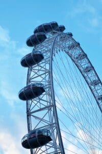 This image features the London Eye with a blue sky background