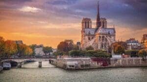 This image features a view of Notre Dame from the back at sunset, with the Seine River in the foreground 
