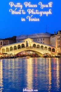 This image features a Pinterest Pin that has the image of Rialto Bridge lit up at nighttime with rainbow colors reflecting off the water. 