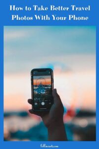 Pinterest Pin titled, How to Take Better Travel Photos With Your Phone. Images includes a hand holds a smartphone capturing a blurry Ferris wheel against a colorful sunset. 
