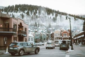 Charming winter street with colorful houses and cars in Park City, Utah.